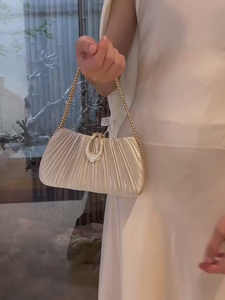 Premium women's party handbag featuring a pleated design and sparkling stone embellishments.