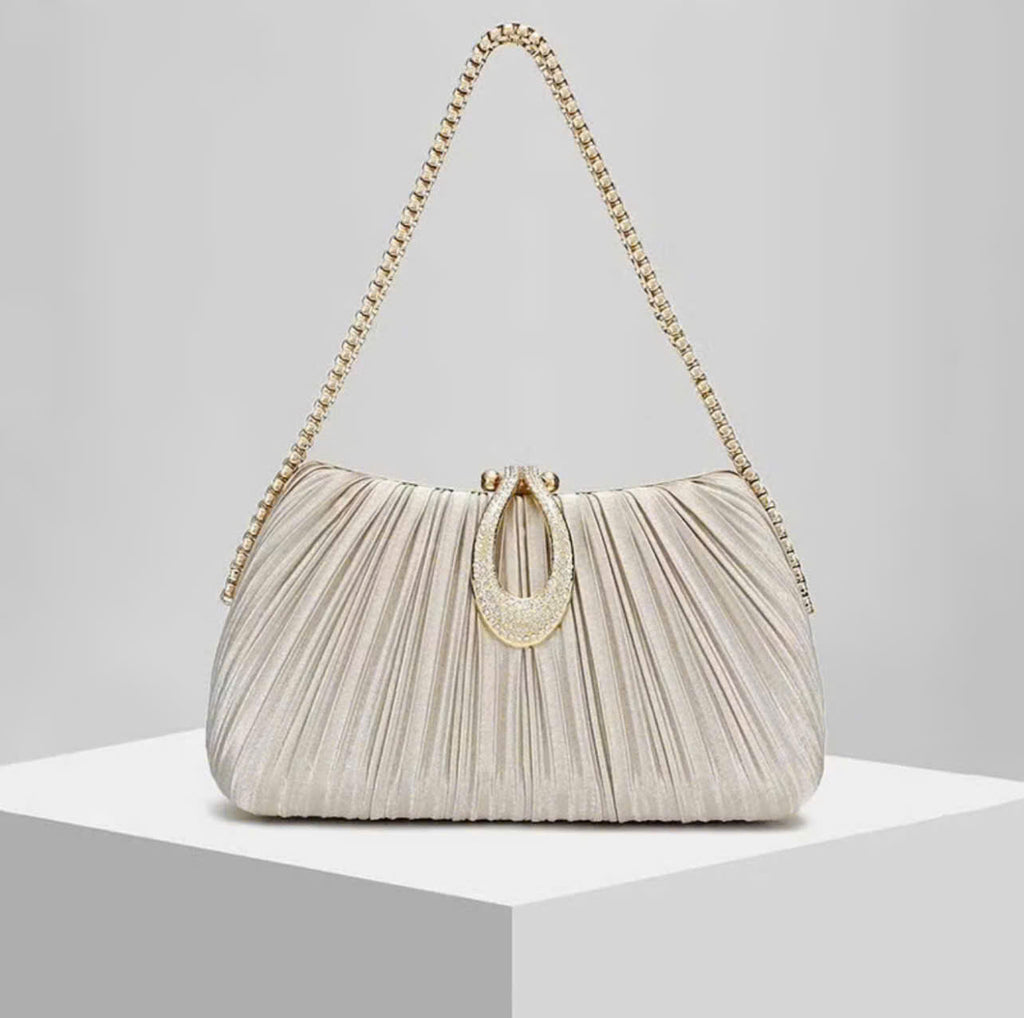 Premium women's party handbag featuring a pleated design and sparkling stone embellishments.