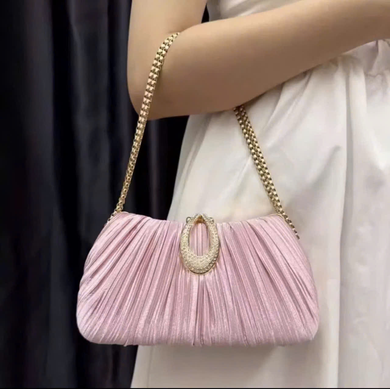 Premium women's party handbag featuring a pleated design and sparkling stone embellishments.